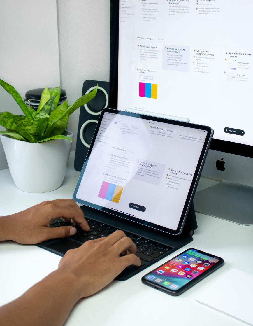Person Working on Tablet Web designer typing on laptop computer