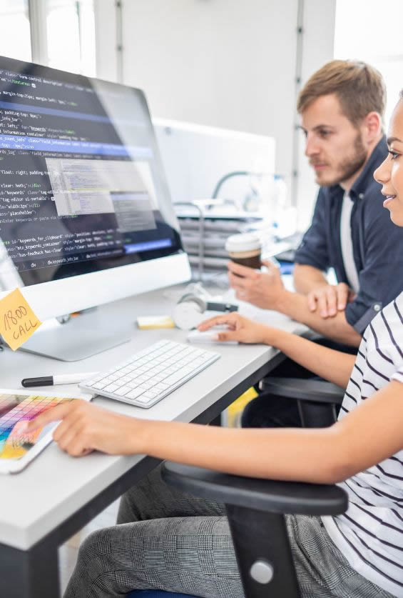 a group of people looking at a computer screen
